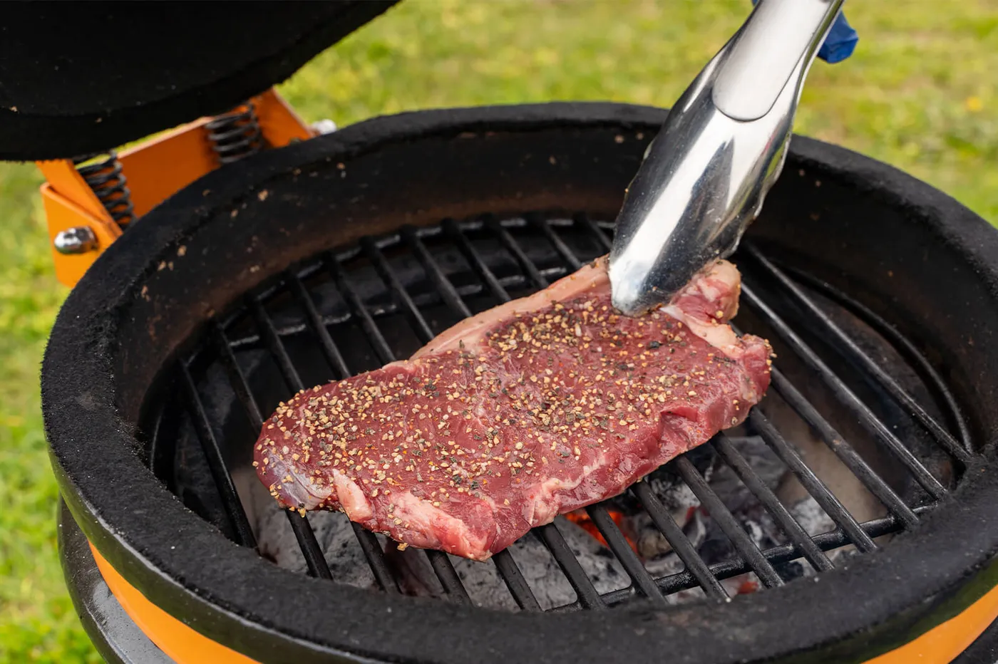 Entrecote die direct boven het vuur op het barbecuerooster ligt